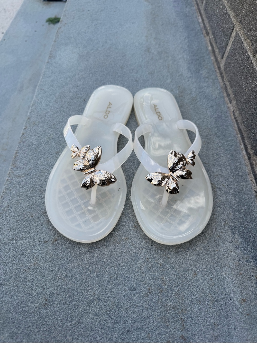 ALDO Clear Jelly Flip Sandals with Gold Butterfly Accents